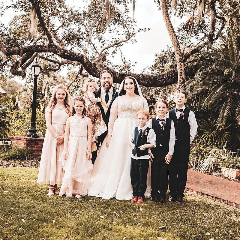 wedding dress and tuxedo with flower girls and ring bearer