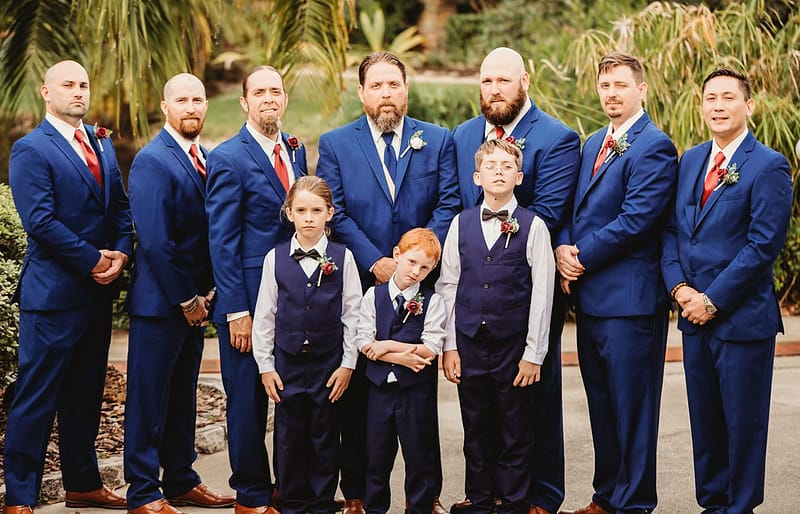 groom and groomsmen in tuxedos with ring bearer
